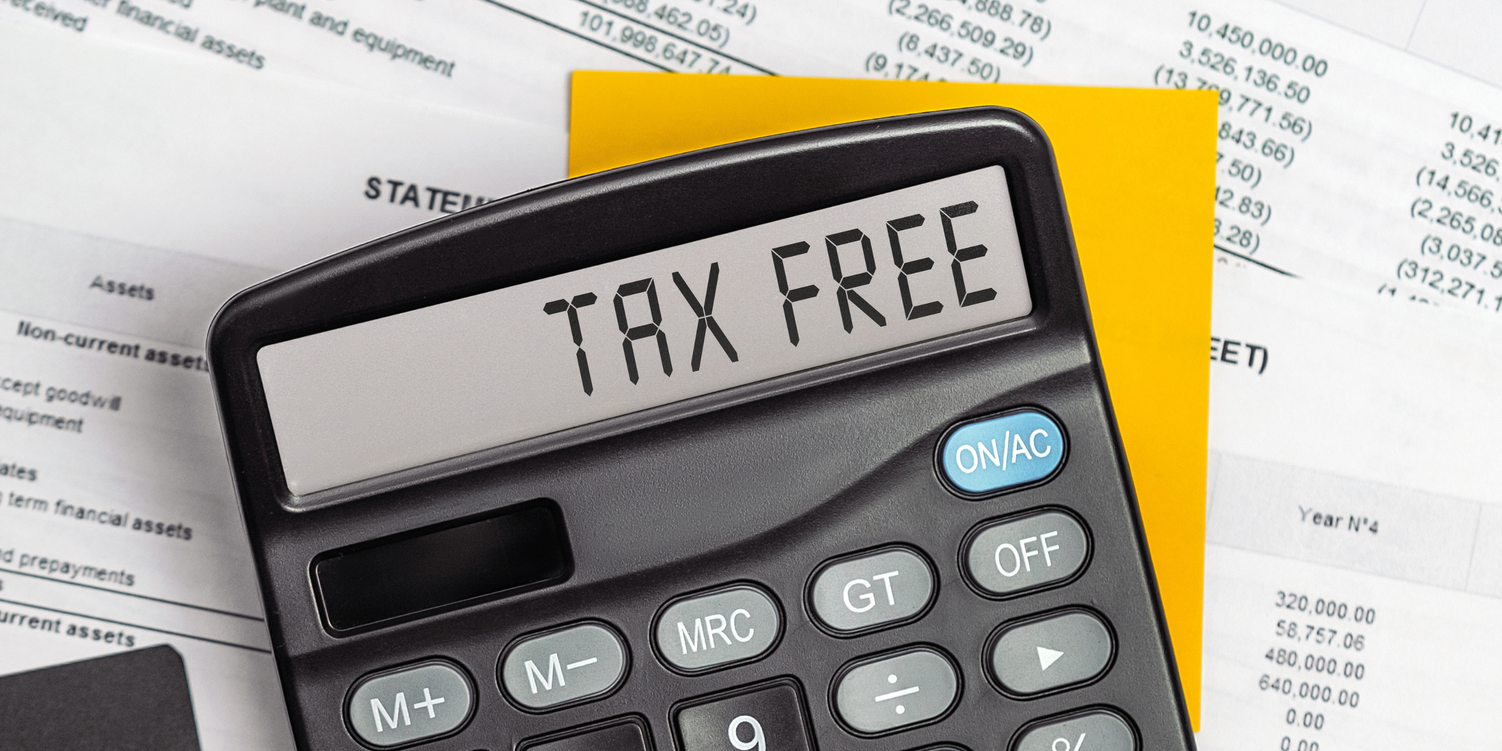 Close-up of a calculator displaying 'TAX FREE' with financial statements in the background, highlighting tax-free vouchers in Ireland.