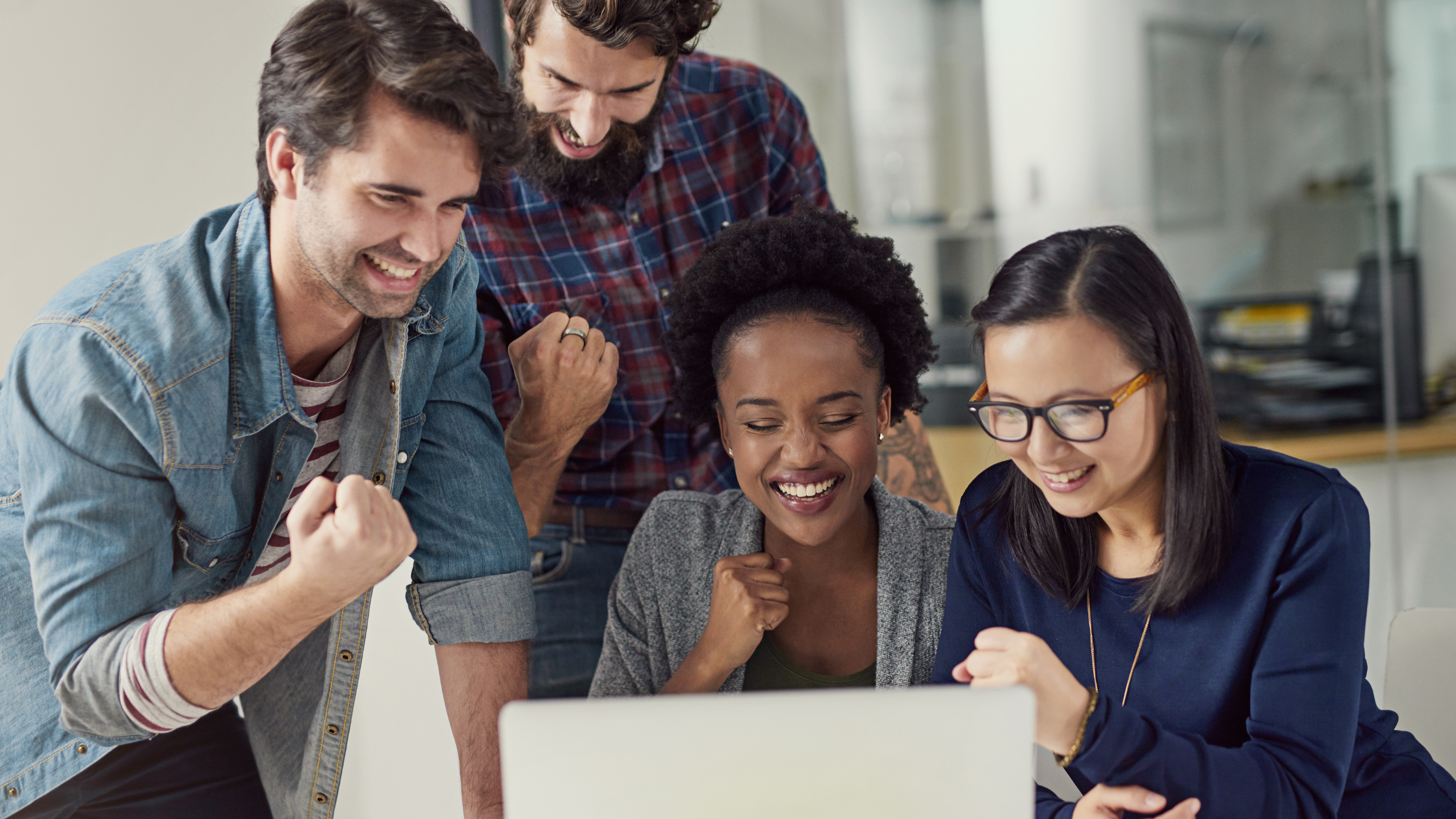 Employees in office attending a meeting signifying benefits or improvements