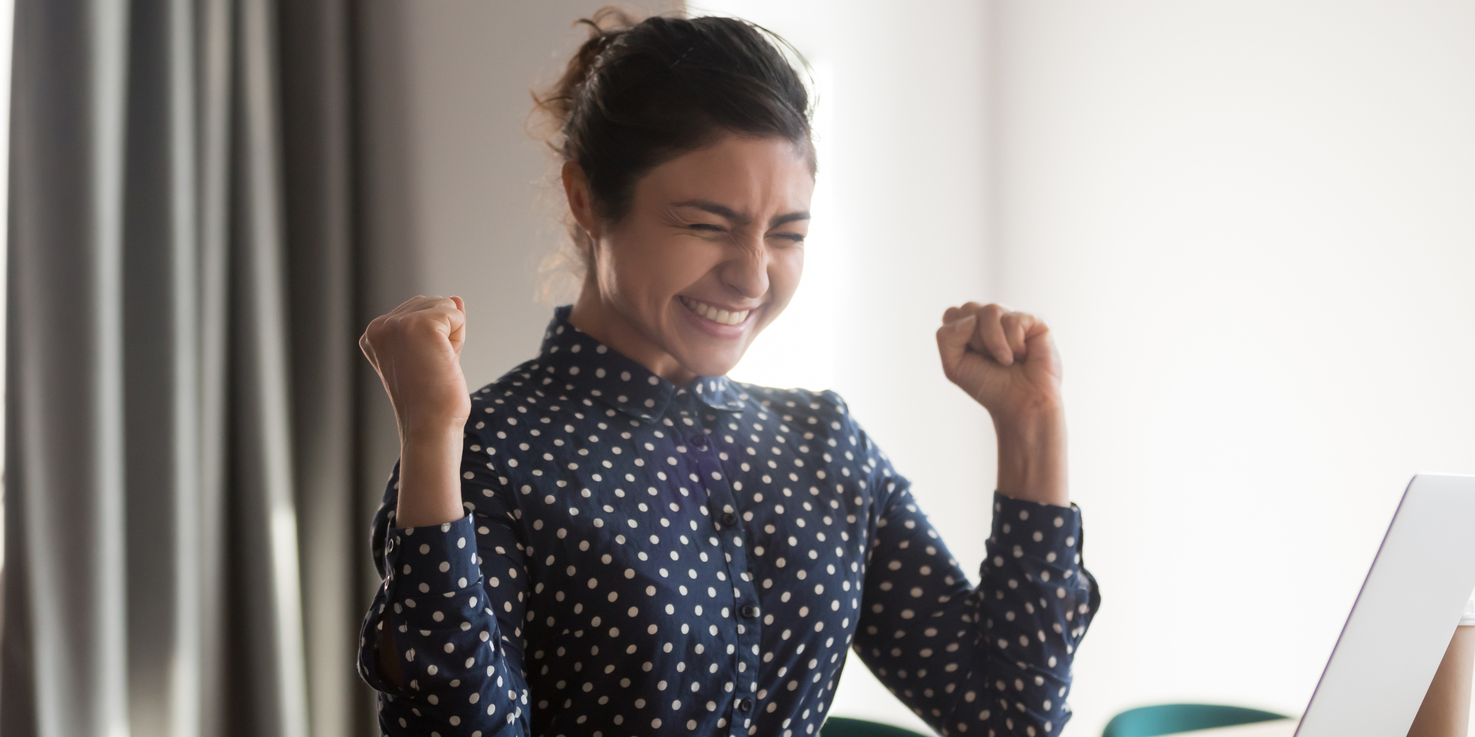 Joyful employee celebrating receiving a SWIRL Prepaid Mastercard Gift Card as a token of appreciation at work