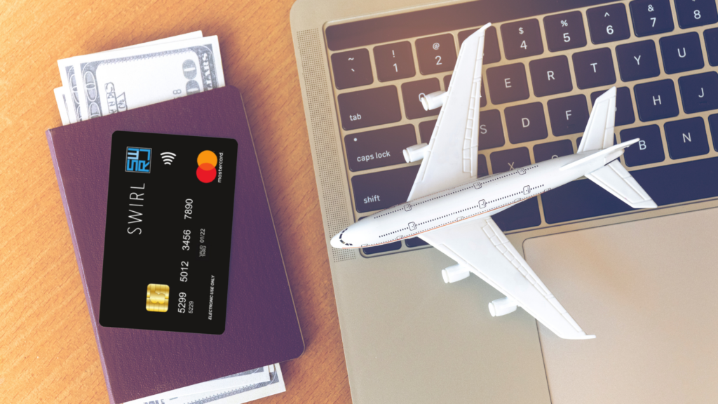 Image with a person making secure online travel plans using their SSWIRL Prepaid Mastercard and their Passport at a laptop