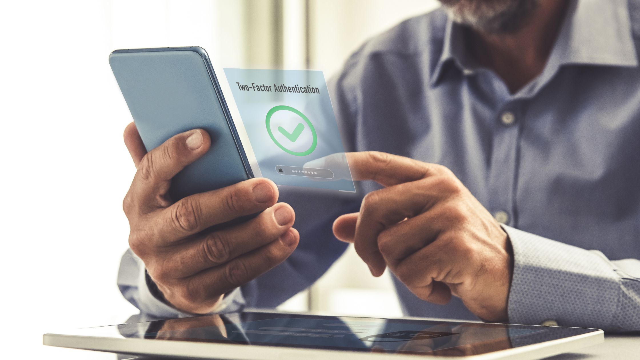The image shows a man holding his smart phone approving 3D Secure, 2 factor Authentication on his online transaction while online shopping